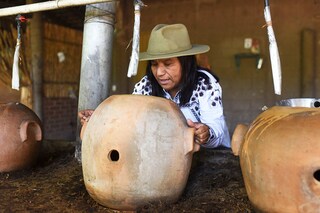 Sosima Olivera, who is member of a collective that runs the mezcal factory Tres Colibries (Three Hummingbirds), moves a clay pot used for distillation at the factory in Villa Sola de Vega, Oaxaca State, Mexico.
Image: Pedro Pardo / AFP