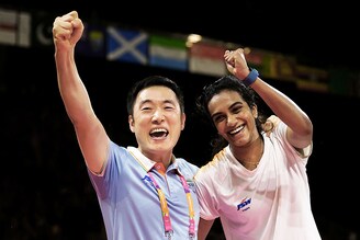 Pusarla Venkata Sindhu of Team India celebrates with Coach, Park Tae-sang, following victory over Michelle Li of Team Canada during the Badminton Women"s Singles Gold Medal Match on day eleven of the Birmingham 2022 Commonwealth Games at NEC Arena on August 08, 2022.