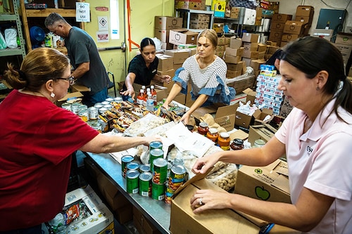 Volunteers organize food donations at a food pantry run by West Houston Assistance Ministries in Houston, Aug. 5, 2022. Many higher income households have been able to keep spending even as costs climb, but data and anecdotes suggest that lower-income households, despite the resilient job market, are struggling more profoundly with inflation. (Meridith Kohut/The New York Times) Volunteers organize food donations at a food pantry run by West Houston Assistance Ministries in Houston, Aug. 5, 2022. Many higher income households have been able to keep spending even as costs climb, but data and anecdotes suggest that lower-income households, despite the resilient job market, are struggling more profoundly with inflation. (Meridith Kohut/The New York Times)