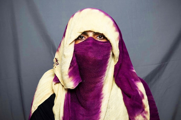 In this photo taken on July 30, 2022, baker Shapari, 40, poses for a portrait in Kandahar. Since their takeover a year ago, the Taliban have squeezed Afghan women out of public life, imposing suffocating restrictions on where they can work, how they can travel, and what they can wear. Image:Â Lillian SUWANRUMPHA / AFP
