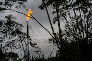 A gas flame burned at an oil well in Putumayo, Colombia on Feb. 6, 2022. One of the world’s largest sustainable development agencies has worked with energy companies to quash opposition and keep oil flowing, even in sensitive areas. (Federico Rios/The New York Times