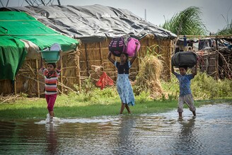 NEW DELHI, INDIA - AUGUST 12: Residents of at Shastri Park living along the bank of Yamuna river move to higher grounds as water level flows above the danger level, on August 12, 2022 in New Delhi, India. The irrigation and flood control department of the Delhi government on Thursday issued the first flood warning for the city after over 300,000 cusecs of water was released into the Yamuna from the Hathnikund barrage in Haryana"s Yamuna Nagar on August 11, 2022.
