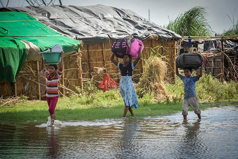NEW DELHI, INDIA - AUGUST 12: Residents of at Shastri Park living along the bank of Yamuna river move to higher grounds as water level flows above the danger level, on August 12, 2022 in New Delhi, India. The irrigation and flood control department of the Delhi government on Thursday issued the first flood warning for the city after over 300,000 cusecs of water was released into the Yamuna from the Hathnikund barrage in Haryana"s Yamuna Nagar on August 11, 2022.