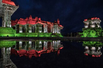 The Hampi temple complexes and the famed stone chariot, a UNESCO World Heritage site, are seen illuminated with the colours of the Indian flag on the eve of the country"s 75th Indian Independence Day celebrations, Vijayanagara, Karnataka.