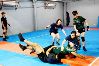This picture taken on May 23, 2022 shows participants playing kabaddi, a tag-wrestling sport popular in South Asia which involves players trying to tag an opponent on the rival"s side before making it back to their own half, in Hong Kong. Overlooked by high-rises on the outskirts of Hong Kong, a group of students practise body-slam tackles and vicious ankle-wrenches at weekly training for an unlikely sport: the ancient Indian game of kabaddi. Image: Peter PARKS / AFP