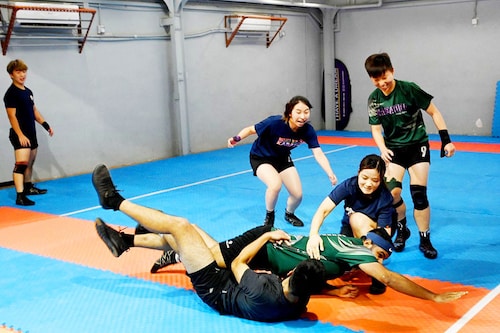 This picture taken on May 23, 2022 shows participants playing kabaddi, a tag-wrestling sport popular in South Asia which involves players trying to tag an opponent on the rival"s side before making it back to their own half, in Hong Kong. Overlooked by high-rises on the outskirts of Hong Kong, a group of students practise body-slam tackles and vicious ankle-wrenches at weekly training for an unlikely sport: the ancient Indian game of kabaddi. Image: Peter PARKS / AFP