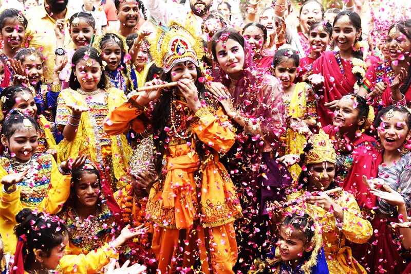 School children dressed as the Lord Krishna and his consort Radha take part in celebrations on the eve of Janmashtami festival, which marks the birth of Krishna, in Amritsar on August 18, 2022.