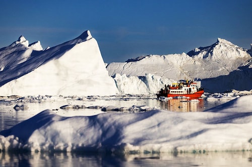 Authorities in Greenland are now mulling ways of controlling crowd numbers in order to protect the fragile environment, already under threat from global warming. Image: Odd Andersen/AFP&nbsp