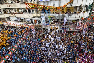 Govindas form a human pyramid to break the Dahi Handi on the occasion of Gokulashtami festival at Dadar on August 19, 2022 in Mumbai, India. The Dahi Handi festival is being celebrated after a gap of two years without any Covid-19 restrictions.