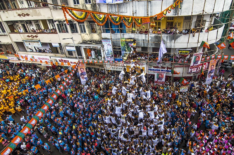 Govindas form a human pyramid to break the Dahi Handi on the occasion of Gokulashtami festival at Dadar on August 19, 2022 in Mumbai, India. The Dahi Handi festival is being celebrated after a gap of two years without any Covid-19 restrictions.