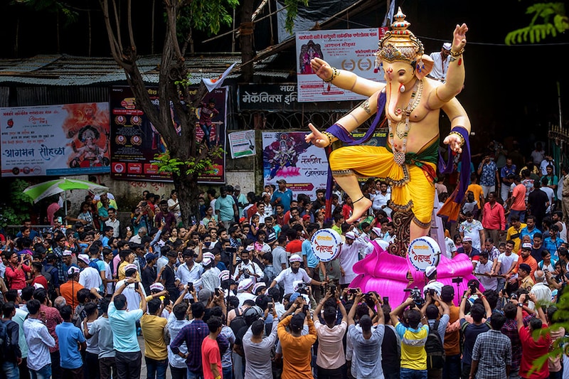 Devotees carry Lord Ganesha idols to pandals for the upcoming Ganesh Chaturthi festival, at Parel, on August 21, 2022, in Mumbai, India.