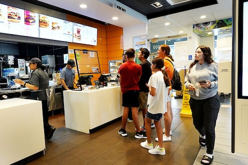 Customers wait to order food at a McDonalds fast food restaurant on July 26, 2022 in Miami, Florida. The McDonald"s company reported U.S. same-store sales rose 3.7%, while international sales rose 9.7% during the most recent quarter. However, it also said that total revenue fell 3% to $5.72 billion it attributed the weakness to slowing demand in China.
Image: Joe Raedle/Getty Images