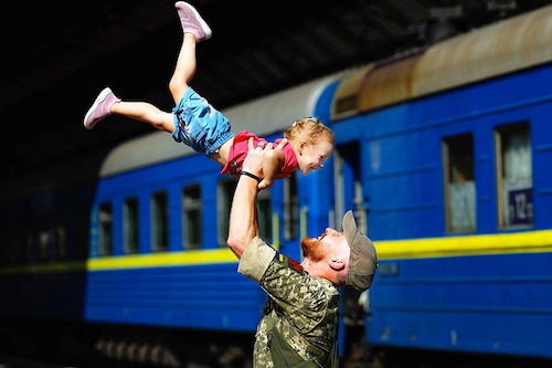 Ukrainian soldier Oleksandr lifts his two-year-old daughter Nikole after they disembarked from a train at Lviv railway station in Ukraine on August 25, 2022. Ukraine is now in the seventh month of war since Russia launched its large-scale invasion of Ukraine on February 24 this year. Lviv has been spared the brunt of that attack, which has focused on central and eastern parts of Ukraine, but the city has been targeted periodically by missile strikes.