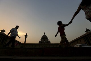 Commuters walk past the building of India"s Ministry of Finance during dusk in New Delhi, India. Image:&nbspAdnan Abidi/ Reuters