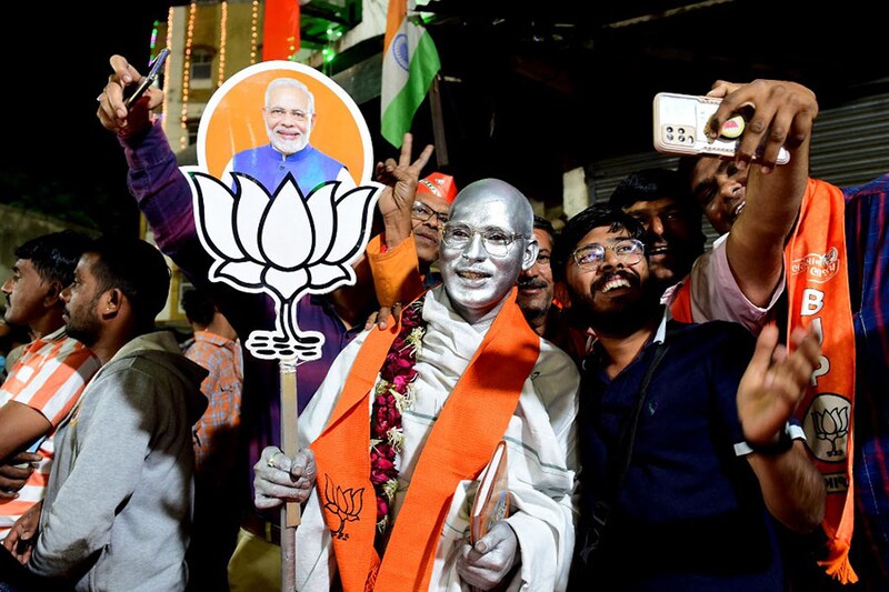 Supporters of the Bharatiya Janata Party cheer during a felicitation program organised for Gujarat State Chief Minister Bhupendrabhai Patel (not pictured) in Ahmedabad on December 8, 2022. BJP won by a crushing landslide in Gujarat, election results showed December 8, in a strong performance ahead of a national vote due in 2024.