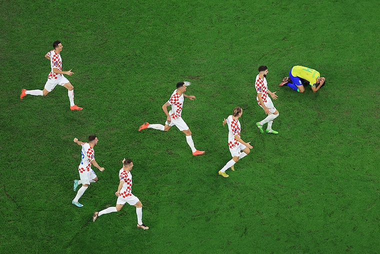 Croatia players celebrate their win via a penalty shootout as Marquinhos of Brazil reacts during the FIFA World Cup Qatar 2022 quarter final match between Croatia and Brazil at Education City Stadium on December 09, 2022 in Al Rayyan, Qatar.