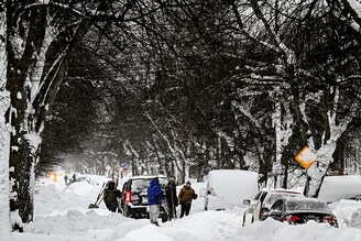 Citizens shovel snow after heavy snowfall in Buffalo, New York, United States on December 26, 2022. Emergency services in New York are struggling to rescue stranded citizens from what authorities called the "blizzard of the century". The snow storm that has left at least 27 dead around Erie County and many of them in Buffalo, is causing US Christmas travel chaos both on the roads as well as at the airports.