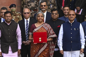 Finance Minister Nirmala Sitharaman along with the ministers of state for finance Pankaj Chaudhary (L) and Bhagwat Kishanrao Karad (R) leave the Finance Ministry to present the annual budget.