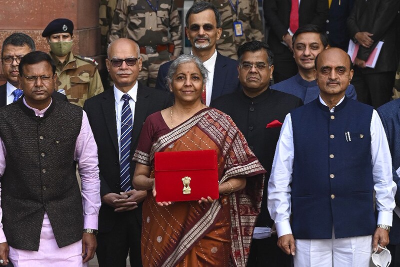 Finance Minister Nirmala Sitharaman along with the ministers of state for finance Pankaj Chaudhary (L) and Bhagwat Kishanrao Karad (R) leave the Finance Ministry to present the annual budget.