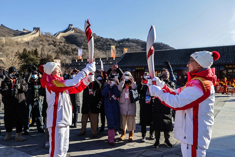 Torchbearers Wu Jingyu, a two-time gold medallist in taekwondo, and actor Jackie Chan relay the Olympic flame at the Badaling section of the Great Wall in Yanqing district.