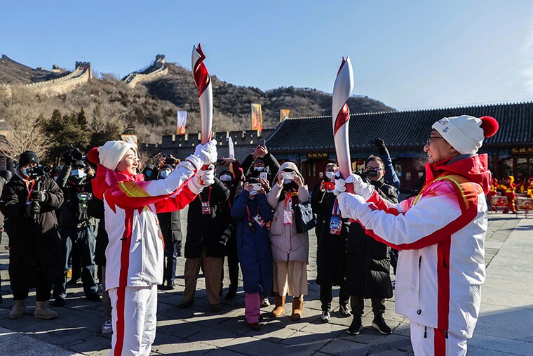 Torchbearers Wu Jingyu, a two-time gold medallist in taekwondo, and actor Jackie Chan relay the Olympic flame at the Badaling section of the Great Wall in Yanqing district.