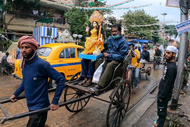 A resident takes home an idol of Saraswati, the goddess representing knowledge and learning, in Kolkata, India, on February 04, 2022. Saraswati Puja is celebrated today, on the same day as Basant Panchami, heralding spring in the country.