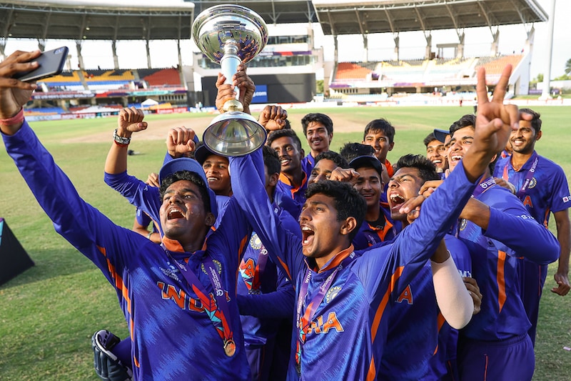 Yash Dhull, captain of India Under-19 cricket team celebrates ICC U19 Men"s World Cup Trophy win at Sir Vivian Richards Stadium with his teammates on February 05, 2022 in Antigua. India defeated England by four wickets to clinch the title for a record fifth time.
