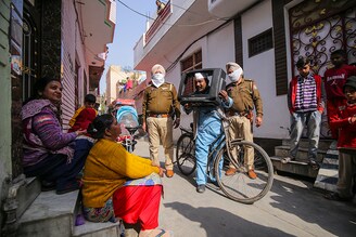 Sham Lal, popularly known as Sham Lal "Gandhi", looks through a television cabinet as he campaigns for the upcoming Assembly elections in a residential area, in Amritsar, India, February 07, 2022. Sham Lal who is contesting the upcoming Assembly elections in Punjab, campaigns uniquely by holding and posing from inside a cabinet of an old television on his bicycle. A follower of Mahatma Gandhi"s philosophy, he came to be known as Sham Lal Gandhi by the local people. Punjab votes on 20 February 2022 for the Assembly elections.