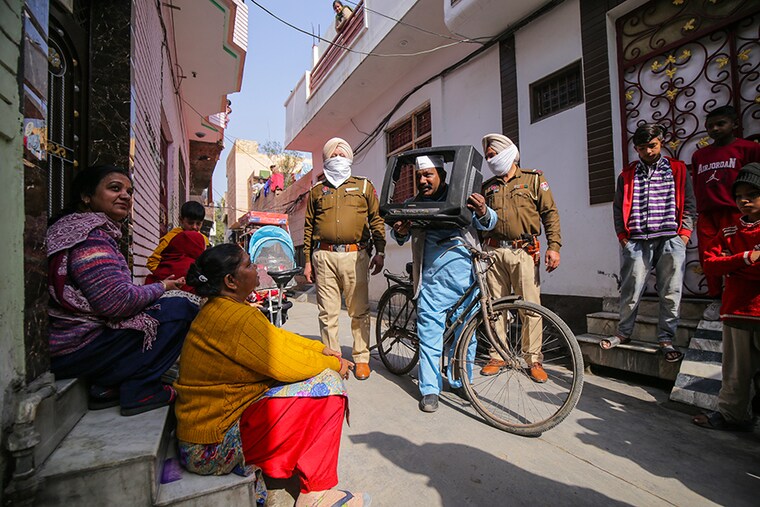 Sham Lal, popularly known as Sham Lal "Gandhi", looks through a television cabinet as he campaigns for the upcoming Assembly elections in a residential area, in Amritsar, India, February 07, 2022. Sham Lal who is contesting the upcoming Assembly elections in Punjab, campaigns uniquely by holding and posing from inside a cabinet of an old television on his bicycle. A follower of Mahatma Gandhi"s philosophy, he came to be known as Sham Lal Gandhi by the local people. Punjab votes on 20 February 2022 for the Assembly elections.