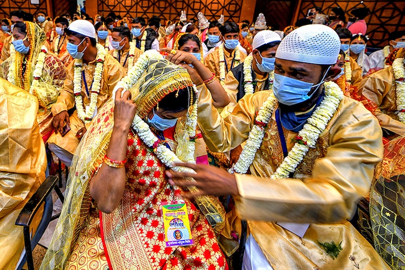 A couple prepares for the Mass Marriage ceremony rituals. An NGO called "Aloy Phera" organised a Mass marriage ceremony of 100 Couples from different religions in Kolkata on Valentines Day to spread the message of love and social harmony. Couples lacking basic financial support took part in this event.