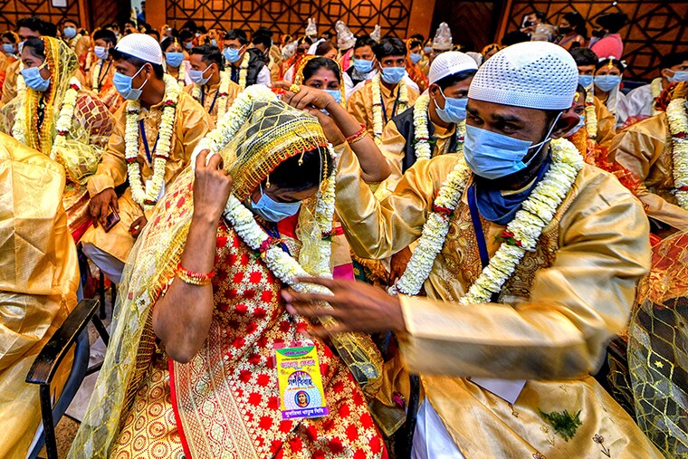 A couple prepares for the Mass Marriage ceremony rituals. An NGO called "Aloy Phera" organised a Mass marriage ceremony of 100 Couples from different religions in Kolkata on Valentines Day to spread the message of love and social harmony. Couples lacking basic financial support took part in this event.
