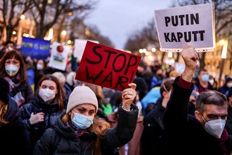 Demonstrators hold placards during an anti-war protest in front of the Russian embassy in Berlin, Germany, February 22, 2022.