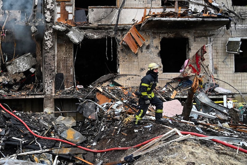 Firefighters work at a damaged residential building at Koshytsa Street, a suburb of the Ukrainian capital Kyiv, where a military shell allegedly hit, on February 25, 2022. - Invading Russian forces pressed deep into Ukraine as deadly battles reached the outskirts of Kyiv, with explosions heard in the capital early Friday that the besieged government described as "horrific rocket strikes". The blasts in Kyiv set off a second day of violence after Russian President Vladimir Putin defied Western warnings to unleash a full-scale ground invasion and air assault that quickly claimed dozens of lives and displaced at least 100,000 people. Image: Genya Savilov / AFP