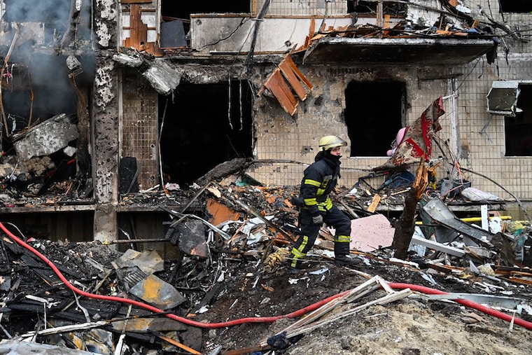 Firefighters work at a damaged residential building at Koshytsa Street, a suburb of the Ukrainian capital Kyiv, where a military shell allegedly hit, on February 25, 2022. - Invading Russian forces pressed deep into Ukraine as deadly battles reached the outskirts of Kyiv, with explosions heard in the capital early Friday that the besieged government described as "horrific rocket strikes". The blasts in Kyiv set off a second day of violence after Russian President Vladimir Putin defied Western warnings to unleash a full-scale ground invasion and air assault that quickly claimed dozens of lives and displaced at least 100,000 people. Image: Genya Savilov / AFP