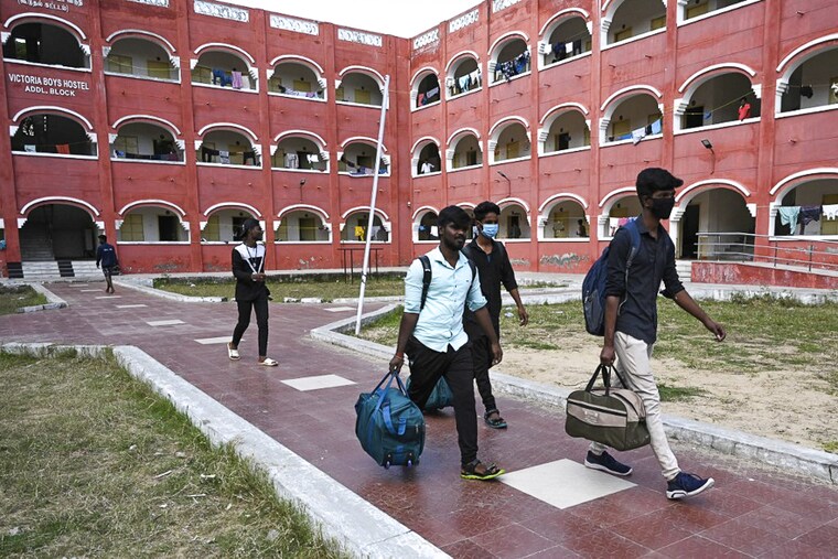 Students from Presidency college vacate their college hostel after a sudden surge in cases of Omicron variant of Covid-19 in Chennai on January 6, 2021. Students nationwide are stressed from disruption of regular classes since the arrival of the virus.
