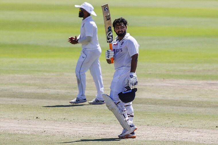 India"s Rishabh Pant (R) celebrates after scoring a century (100 runs) during the third day of the third Test cricket match between South Africa and India at Newlands stadium in Cape Town on January 13, 2022.