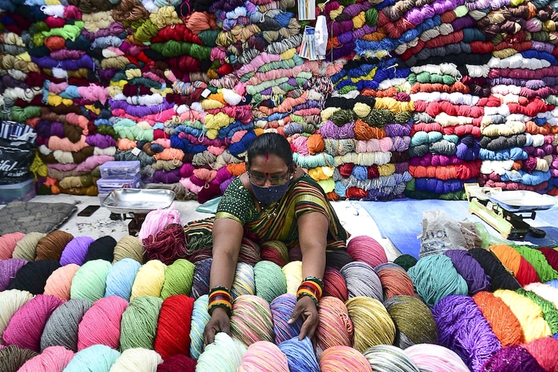 A roadside vendor arranges woollen yarn in Ahmedabad on January 24, 2022. The GST Council has notified a uniform 12% rate for synthetic and artificial yarn effective from the beginning of January this year.