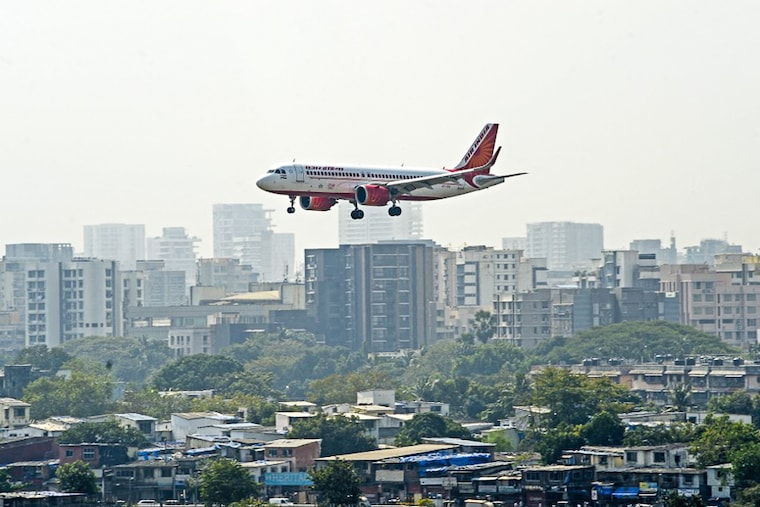 An Air India aircraft prepares to land at the Chhatrapati Shivaji Maharaj International Airport in Mumbai on January 27, 2022. The government on Thursday officially handed over Air India to the Tata group, a strategic disinvestment transaction that concluded with the transfer of 100 per cent shares of Air India to Tatas.