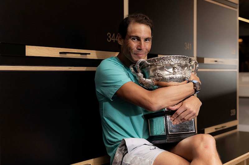 In this handout photo provided by Tennis Australia, Rafael Nadal poses with the Australian Open men"s singles final trophy in the locker room following his win at Melbourne Park on January 31, 2022 in Melbourne, Australia.