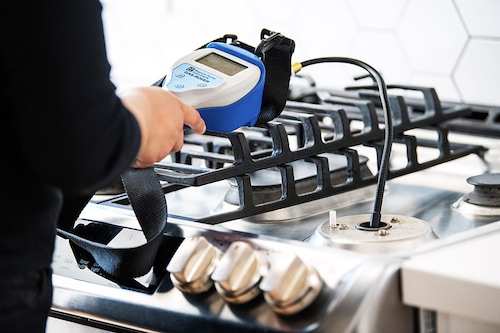 An undated photo provided by Brett Tryon shows a researcher collecting a sample of unburned natural gas from a kitchen stove. A study has found that the natural gas delivered to homes contains low concentrations of several chemicals linked to cancer. (Brett Tryon/The New York Times)