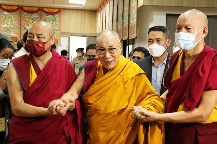 Tibetan spiritual leader Dalai Lama (C) is assisted as he arrives for the inaguaration of a museum on his 87th birthday, in Dharamsala on July 6, 2022.