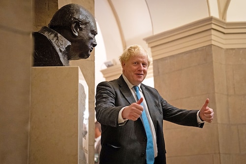 Prime Minister Boris Johnson of the United Kingdom poses near a bust of British Prime Minister Winston Churchill during a visit to the U.S. Capitol in Washington on Sept. 22, 2021. Johnson said on Thursday, July 7, 2022, that he would step down as prime minister, after a wholesale rebellion of his cabinet, a wave of government resignations and a devastating loss of party support prompted by his handling of the party’s latest sex-and-bullying scandal. (Sarahbeth Maney/The New York Times)