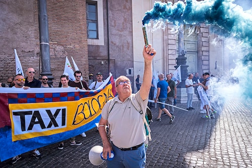 Protesters attend a national demonstration of taxi drivers to demand the withdrawal of Article 10 of the "Competition" bill introduced by the Draghi government which, the unions explain, "benefits multinationals" such as Uber on July 5, 2022 in Rome, Italy. This is the first day of a two-day strike by taxi drivers who are protesting a bill by the government that will liberalize the sector. Drivers argue the changes will favor multinational companies like Uber over independent drivers. Image:&nbspStefano Montesi / Corbis via Getty Images