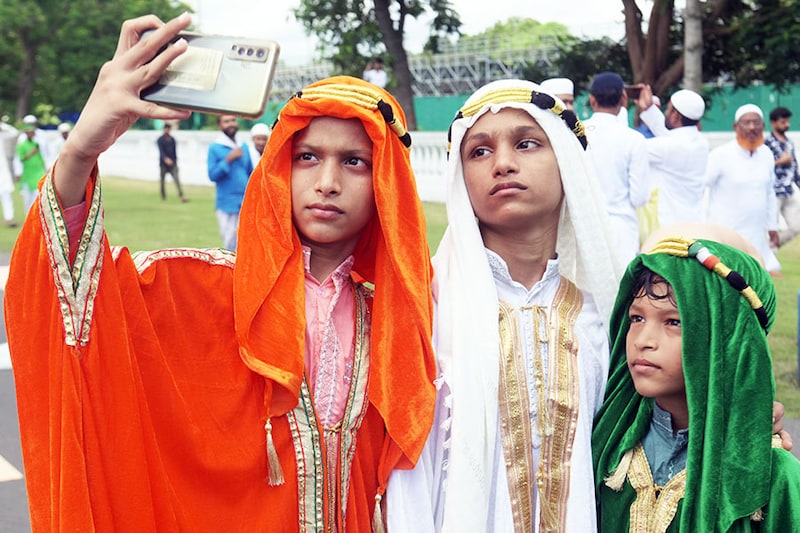 Young devotees dressed in tricolour take a selfie after offering prayers on the occasion of Eid al-Adha on July 10, 2022, in Kolkata, India. On this occasion, family elders gift money to the young and offer food to those who are less fortunate.