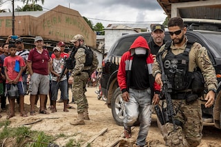 Police escort Amarildo Oliveira, who confessed to killing Bruno Pereira and Dom Phillips, in Atalaia do Norte, Brazil, June 15, 2022. The murders of Pereira, who wanted to protect the Amazon and its Indigenous people, and Phillips, who wanted to show how Indigenous communities were trying to defend themselves from poachers, is the story of two men killed while pursuing their passions. (Victor Moriyama/The New York Times)