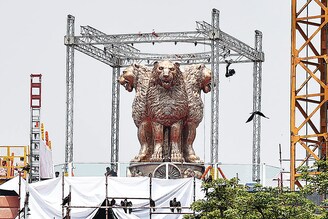 A 6.5-metre bronze cast of Ashok Stambh, India"s national emblem, weighing 9500 kg is unveiled on the roof of the new Parliament building on July 11, 2022, in New Delhi, India. Built by Tata Projects, the new Parliament building will most likely be completed by October-November 2022, to hold the winter session this year, to coincide with the 75th year of India’s independence.