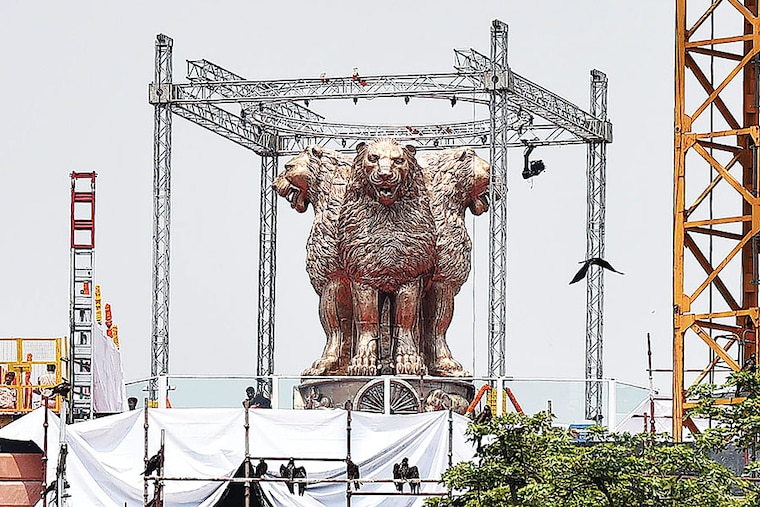 A 6.5-metre bronze cast of Ashok Stambh, India"s national emblem, weighing 9500 kg is unveiled on the roof of the new Parliament building on July 11, 2022, in New Delhi, India. Built by Tata Projects, the new Parliament building will most likely be completed by October-November 2022, to hold the winter session this year, to coincide with the 75th year of India’s independence.