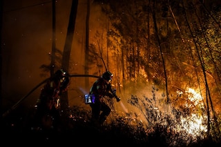 Firefighters spray water to extinguish a wildfire near Besseges, southern France, on July 7, 2022.&nbsp Image:&nbspSylvain Thomas / AFP