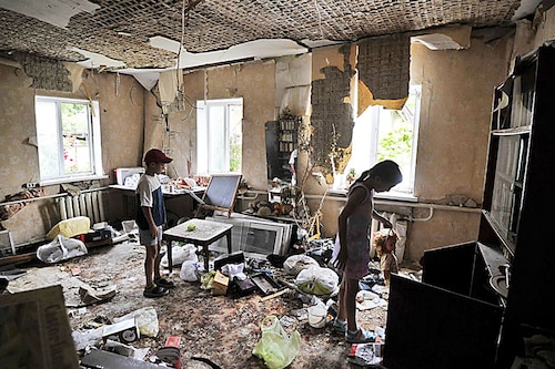 Children inspect a room damaged by the shelling in the town of Borodianka, near Kyiv on July 7, 2022. Image:&nbspSergei Chuzavkov / AFP