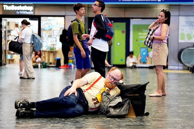 Rail passengers await announcements at Euston train station in central London, on July 19, 2022, as services were cancelled due to a trackside fire on a day that the country experienced an extreme heat wave. After the UK"s warmest night on record, the Met Office said 40.2C had been provisionally recorded by lunchtime at Heathrow Airport, in west London, taking the country into uncharted territory.